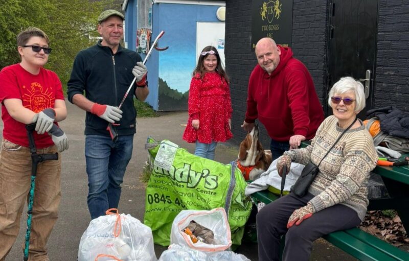 Labour volunteers take a break around some of the bags of litter collected from Kingston Road Recreation Ground